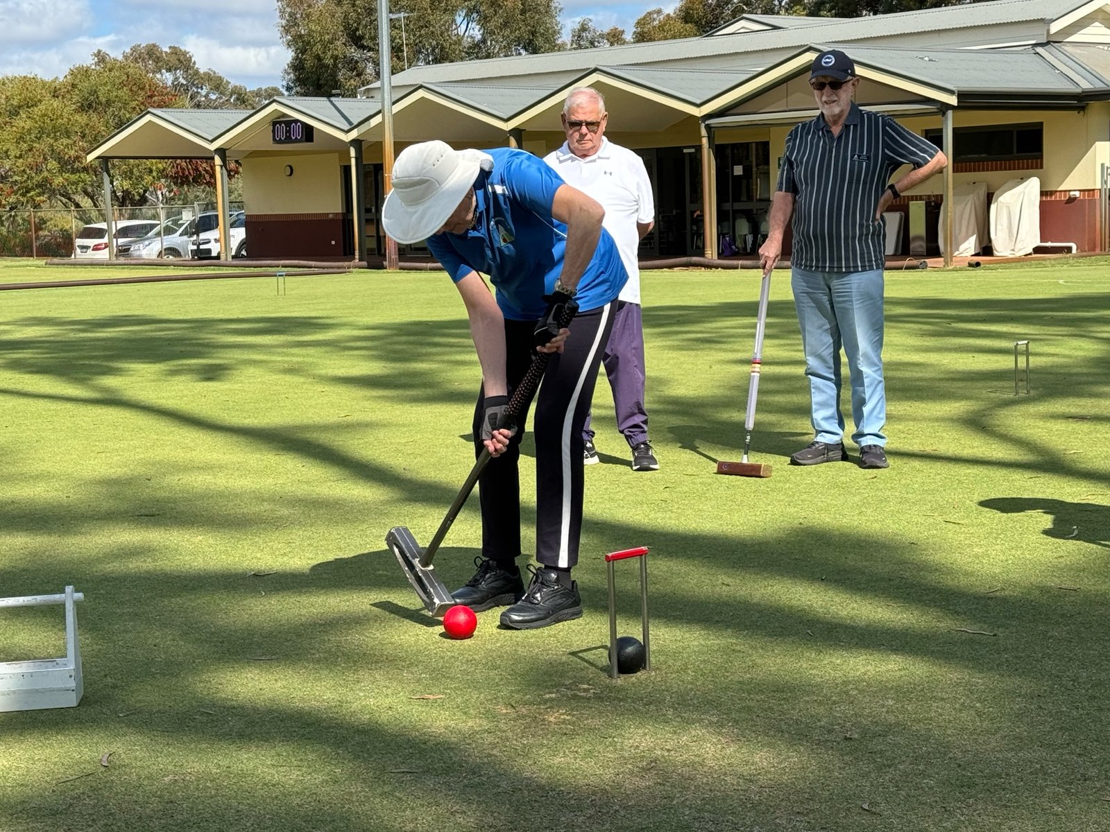 A coach helping a newcomer with their first shot